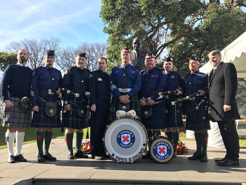 Pipe and drum band posing for photo